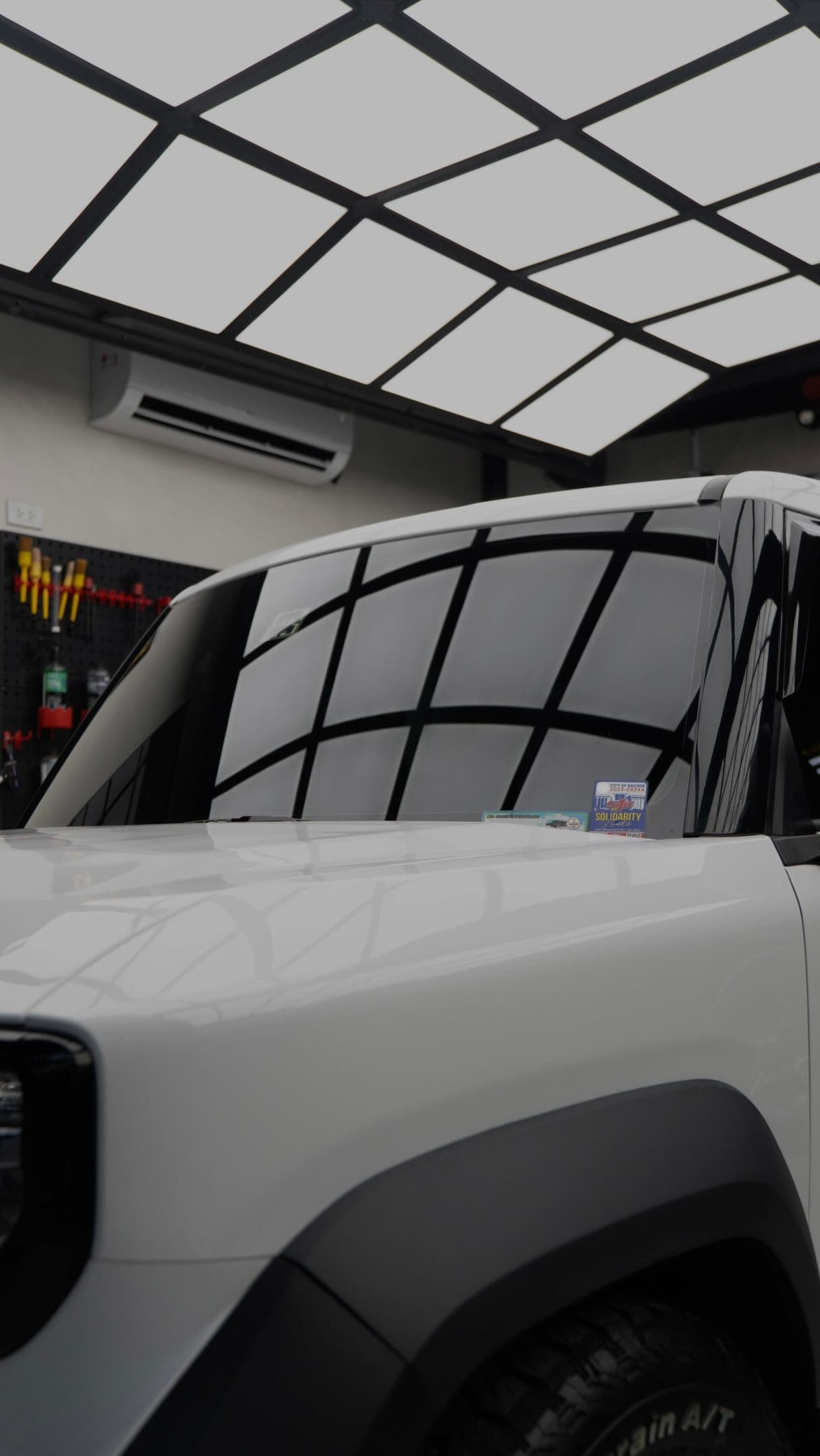 White SUV with a ceramic-coated gloss finish in the BNT Garage bay