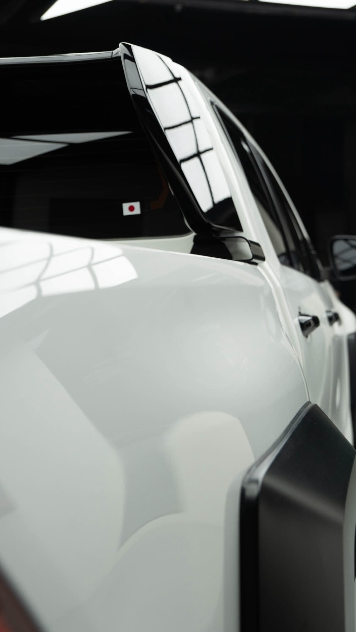 White sports car detail showing corrected, glossy paint
