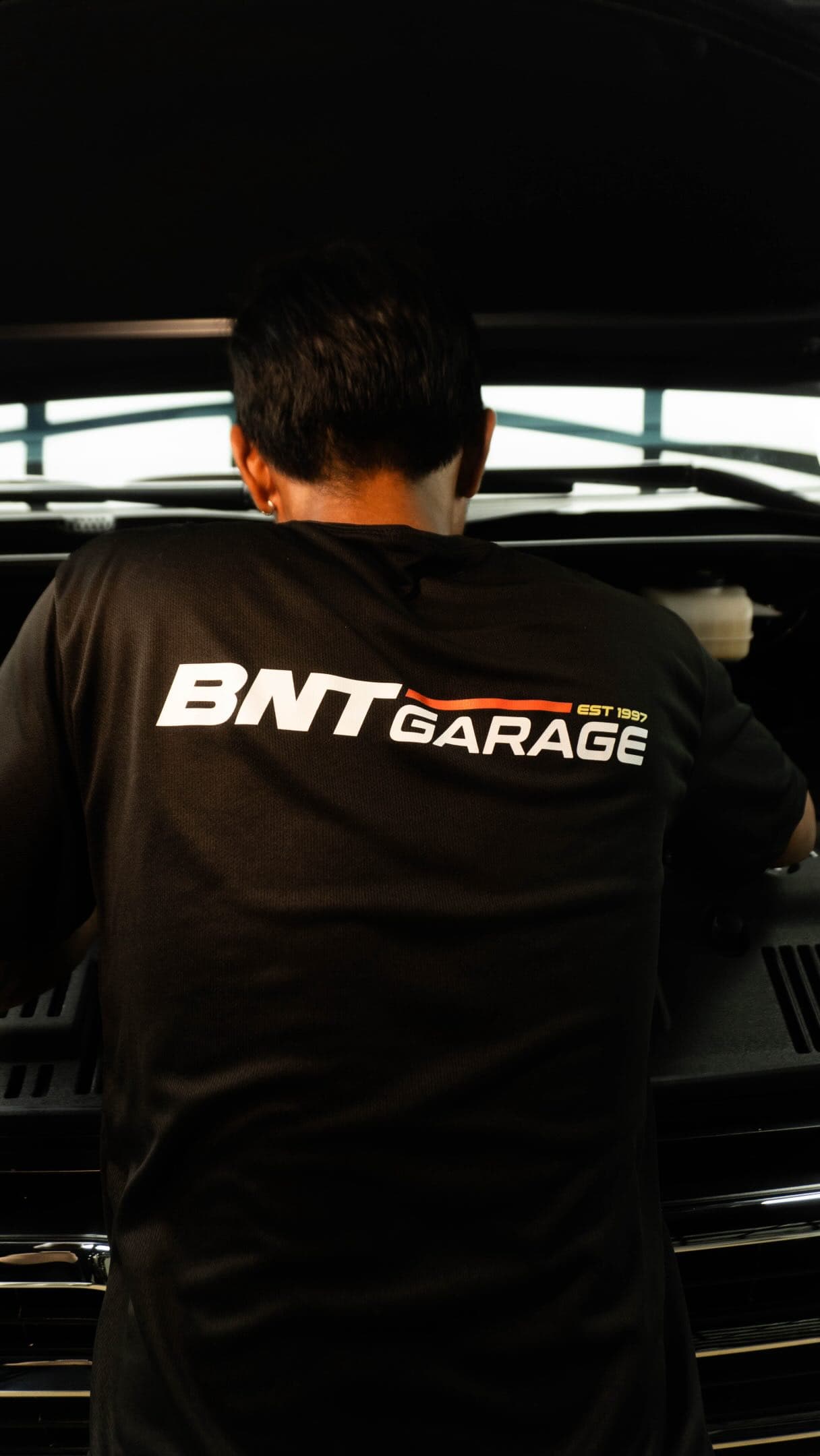 BNT Garage technician working over an open engine bay